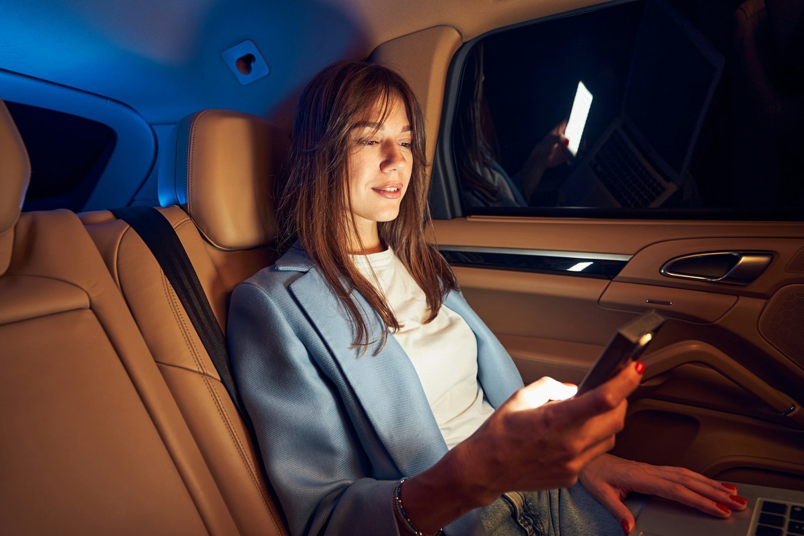 smiling-woman-using-mobile-phone-in-car.jpg